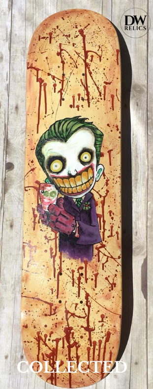 Hand-painted skateboard deck featuring an insane clown on a bloody background, original artwork on wood by Dave Plaza